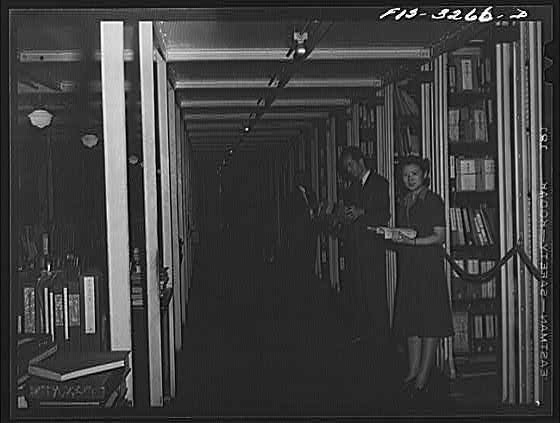 Photo:Library Interior 1940s Man and Woman Browsing Books Shelves