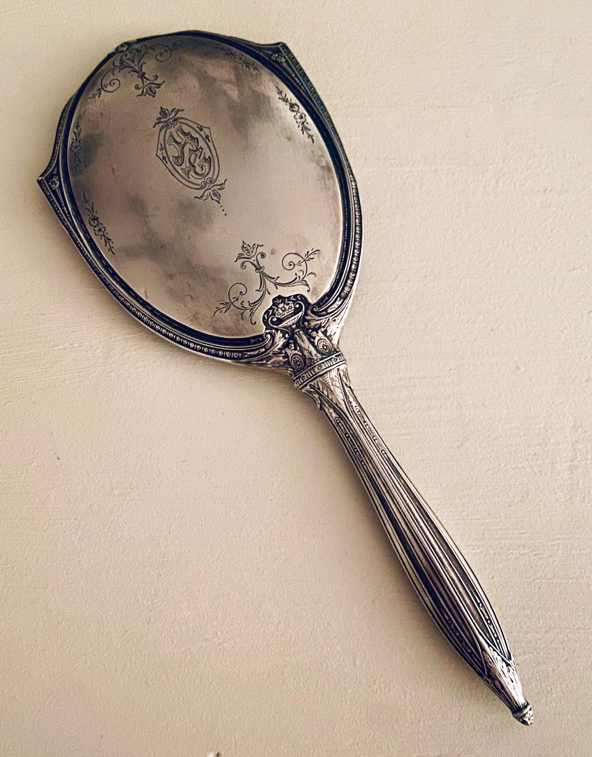 Antique silver-tone/likely silver-plated vanity hand mirror circa early 20th C Antique silver-tone/likely silver-plated vanity hand mirror circa early 20th C
