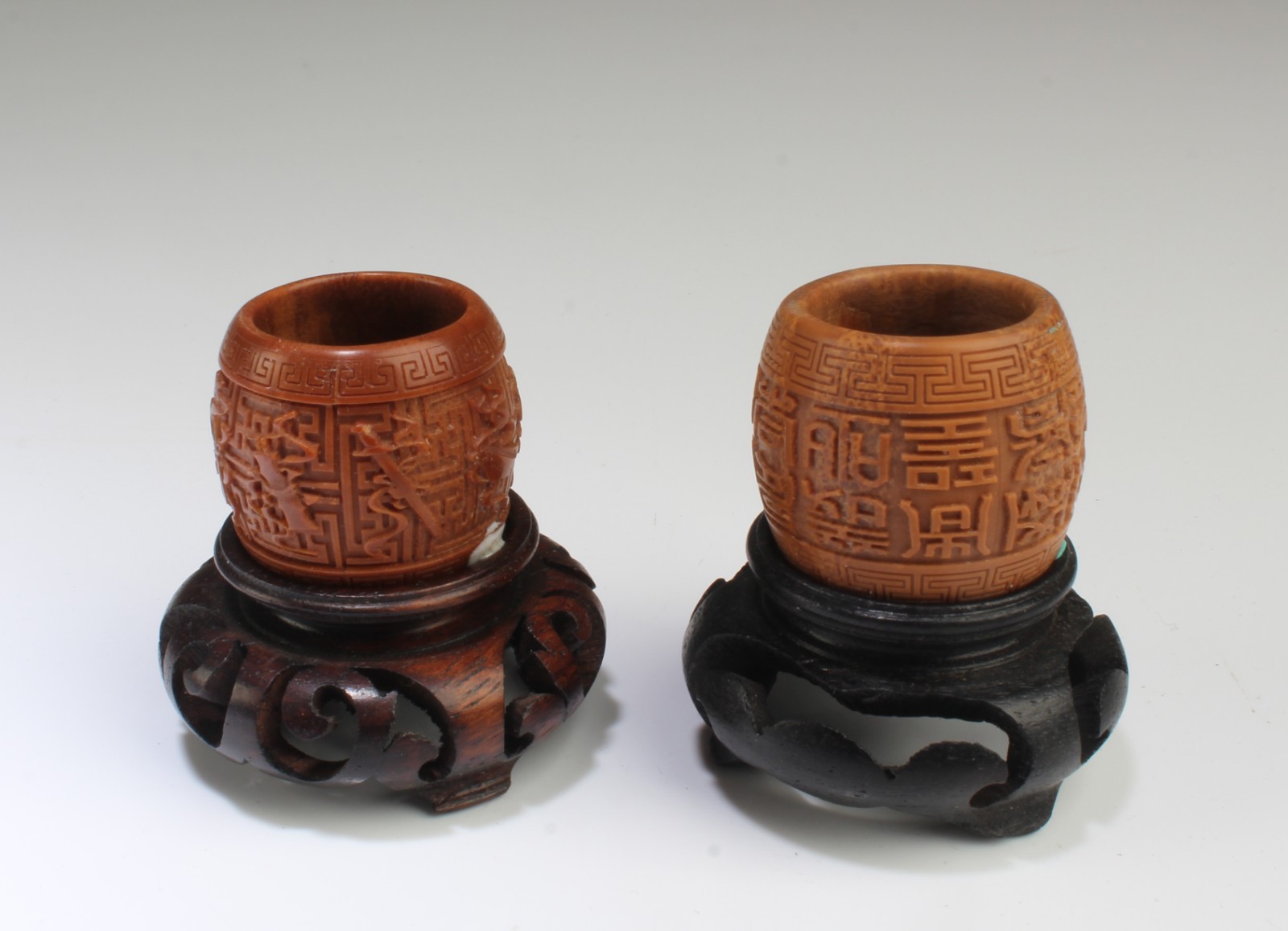 A Group of Two Carved Walnut Ornament. Comes fitted with a wooden stand A Group of Two Carved Walnut Ornament. Comes fitted with a wooden stand