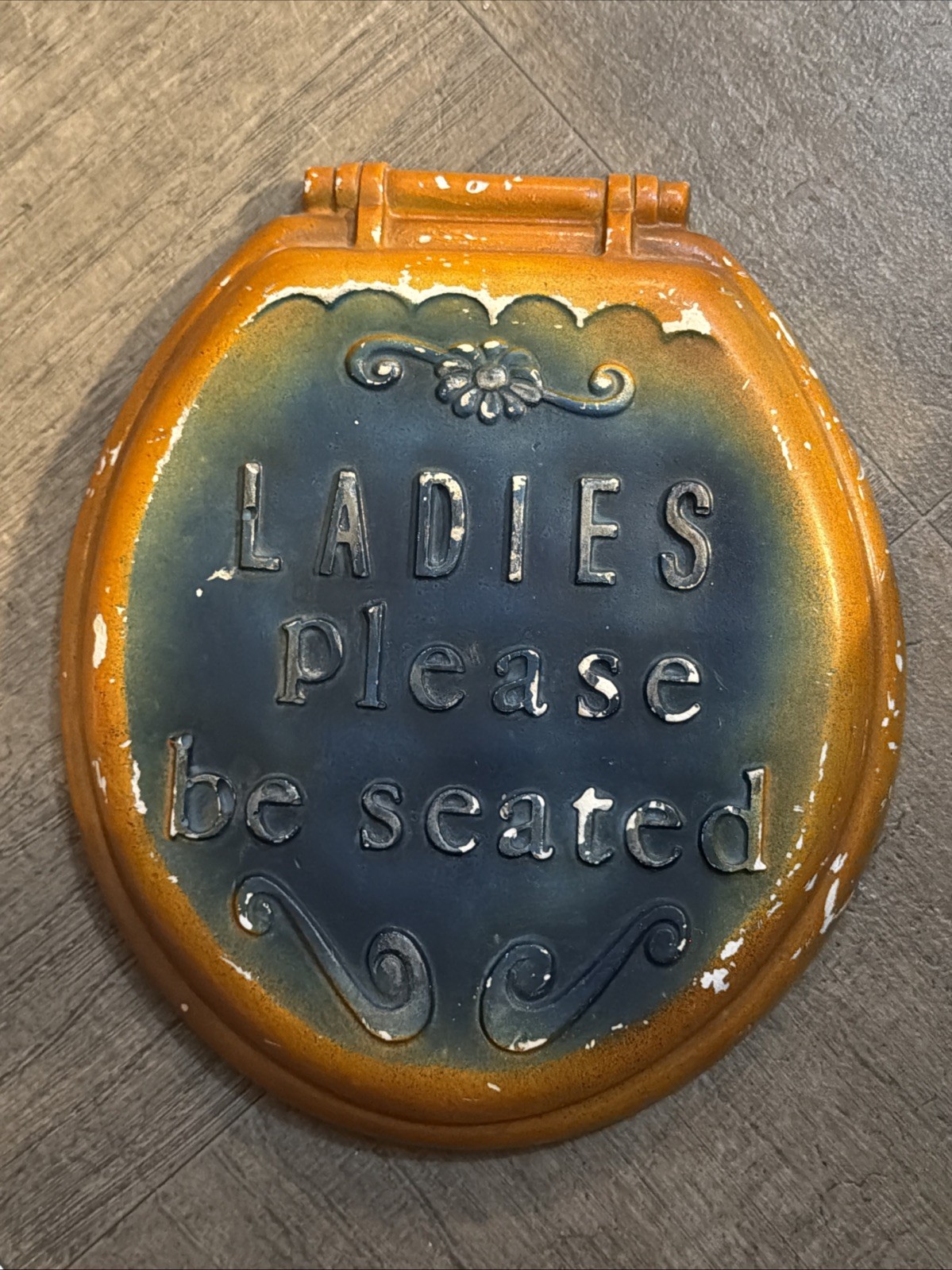 Vintage ceramic sign with the phrase 'Ladies Please be seated' embossed on it. Vintage ceramic sign with the phrase 'Ladies Please be seated' embossed on it.