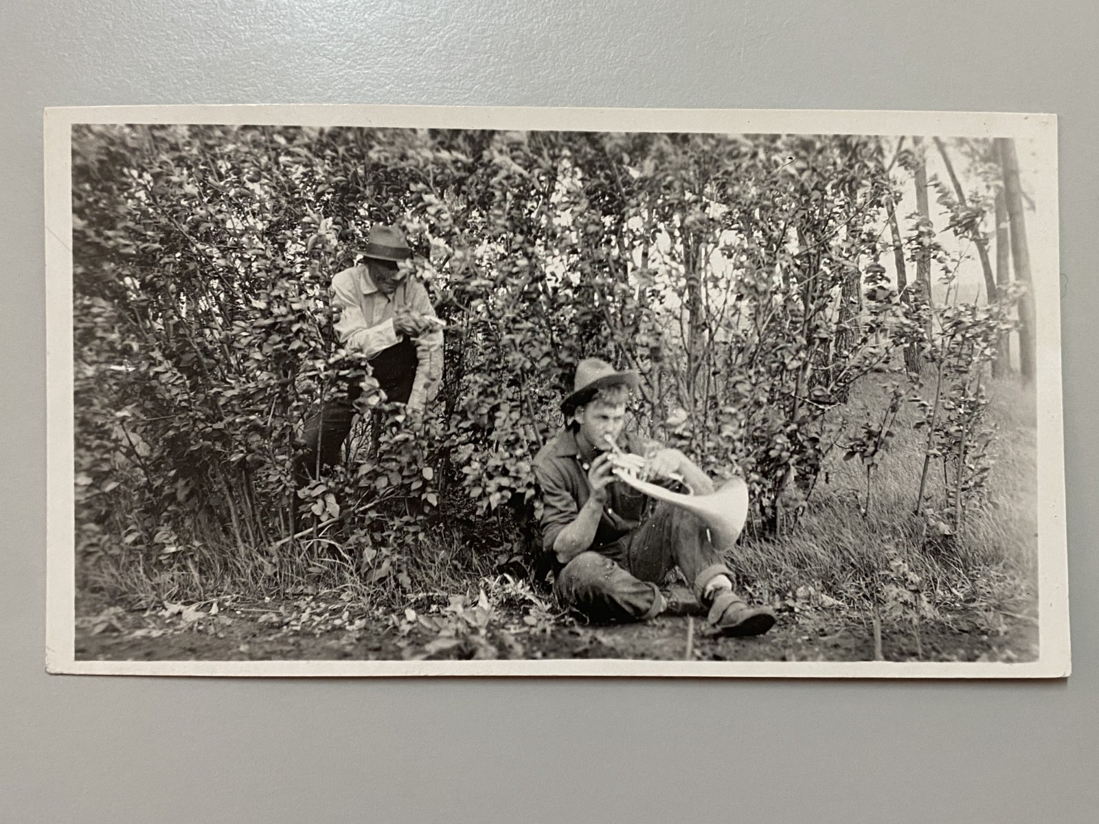 1920s Terry Montana RPPC Postcard Boy Horn Player Man Hiding Bush Gun Gag Photo