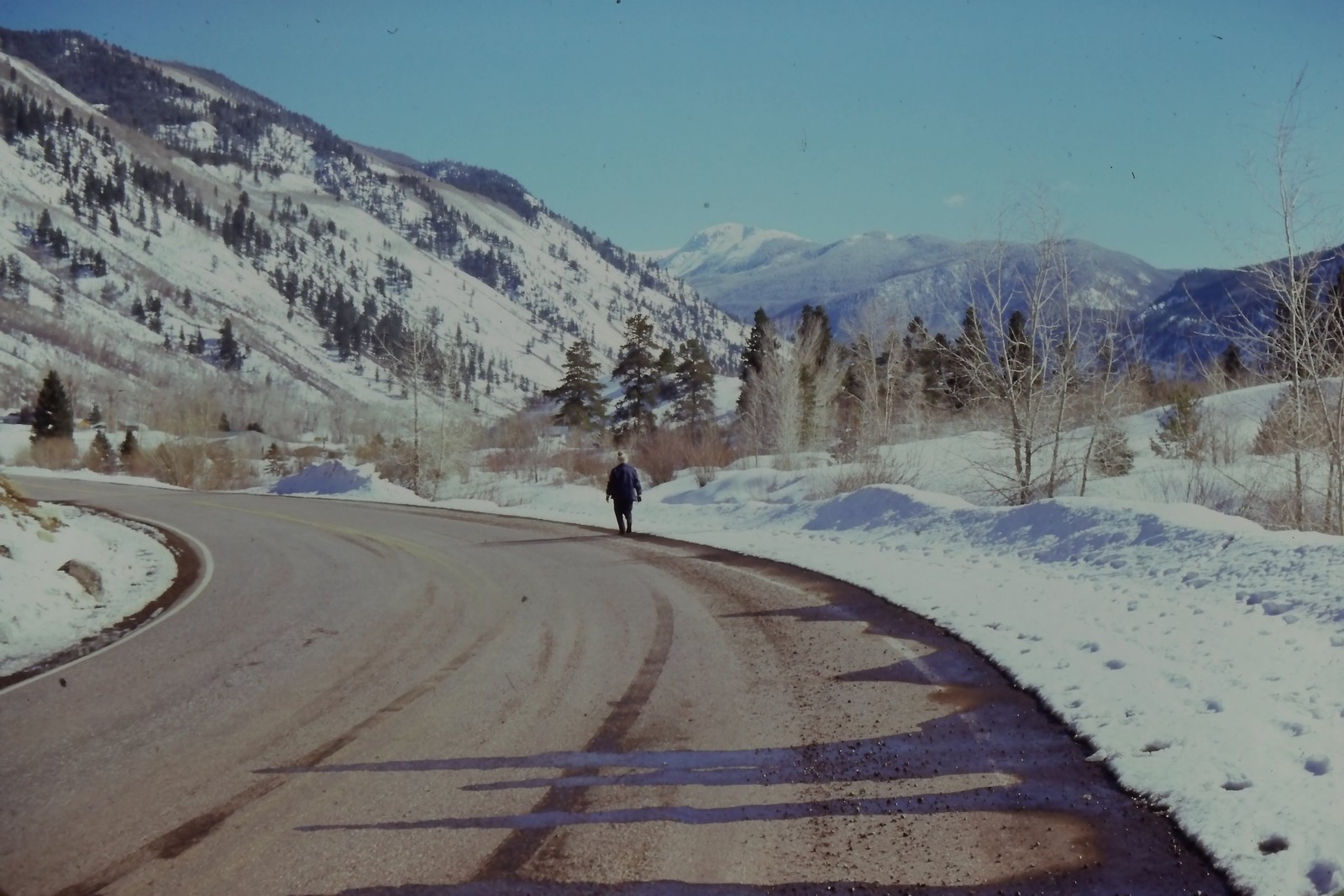 c1960\'s Kodachrome 35mm Slide Lone Person Walking Snowy Mountain Road Aspen c1960\'s Kodachrome 35mm Slide Lone Person Walking Snowy Mountain Road Aspen