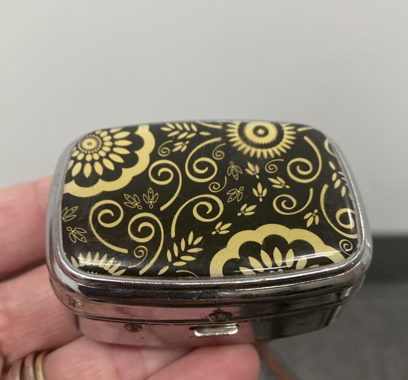 Retro Hinged 2 Slot Pill Box. Yellow Black Flower. W/ Mirror. 2.1/4 “L x 1” T A Retro Hinged 2 Slot Pill Box. Yellow Black Flower. W/ Mirror. 2.1/4 “L x 1” T A