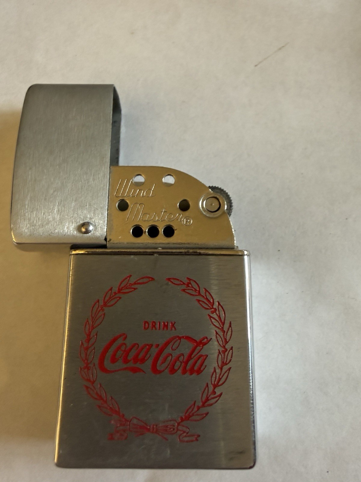 Vintage Coca-Cola advertising Oil Lighter With Laurel Wreath Motif