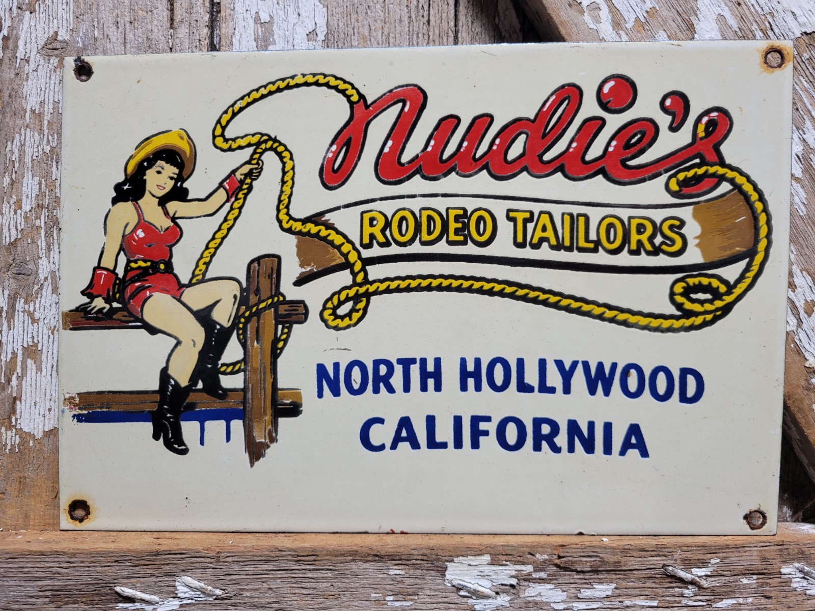 VINTAGE NUDIES PORCELAIN SIGN RARE OLD RODEO TAILOR HOLLYWOOD CALIFORNIA COWGIRL
