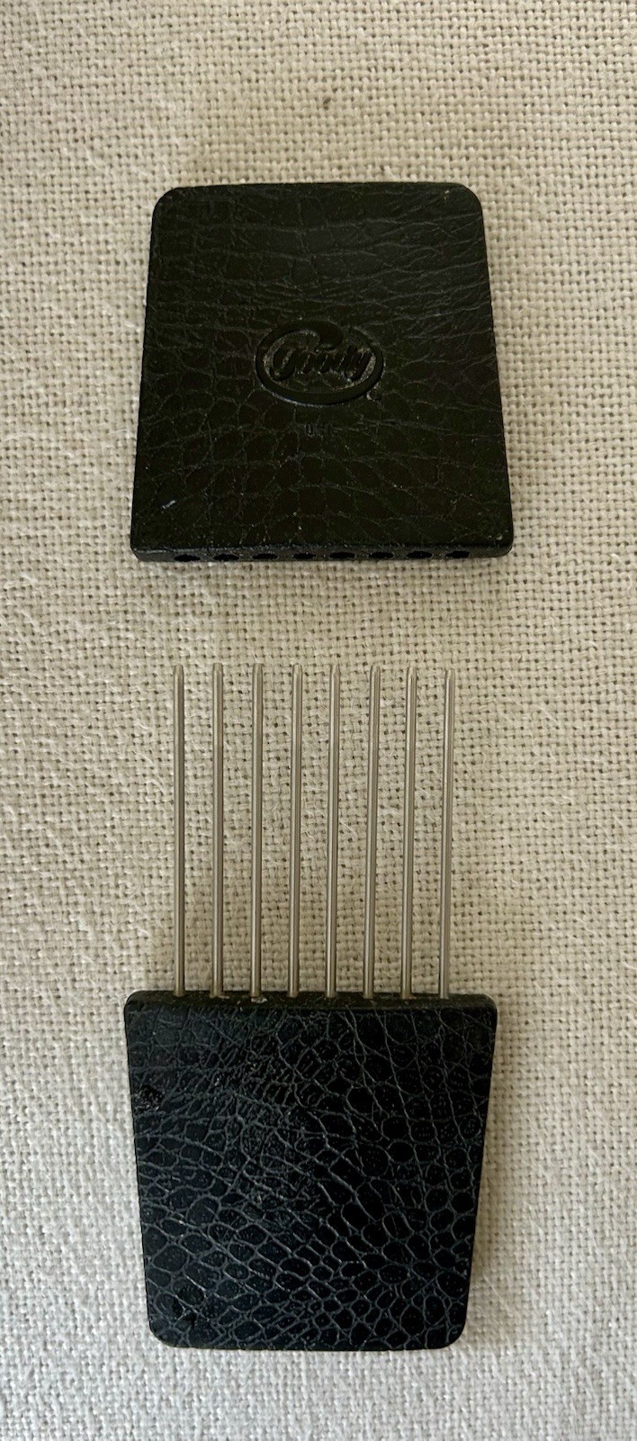 This item is a vintage Goody travel hair pick featuring a protective slipcover.