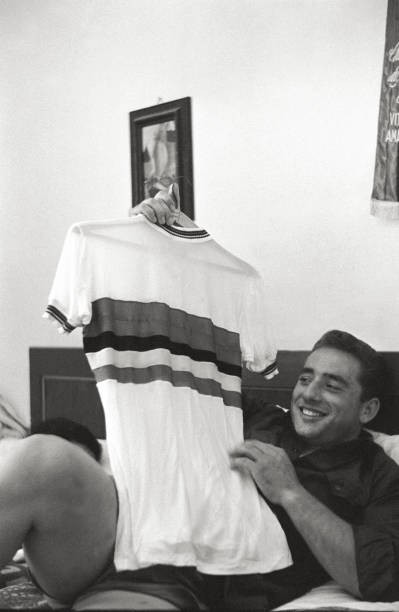 The Italian cyclist Sante Gaiardoni showing a jersey while lying a- Old Photo