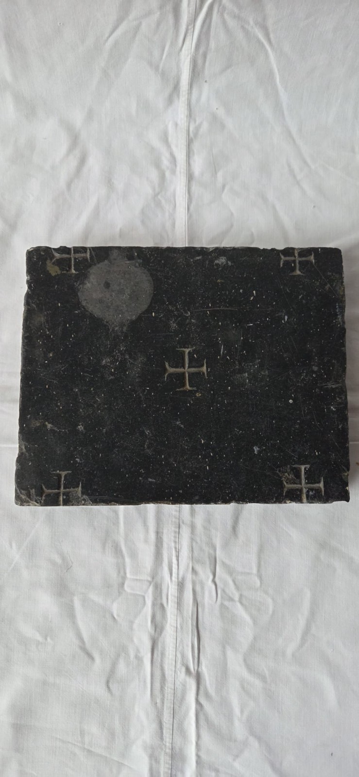 Black marble altar stone with a relic