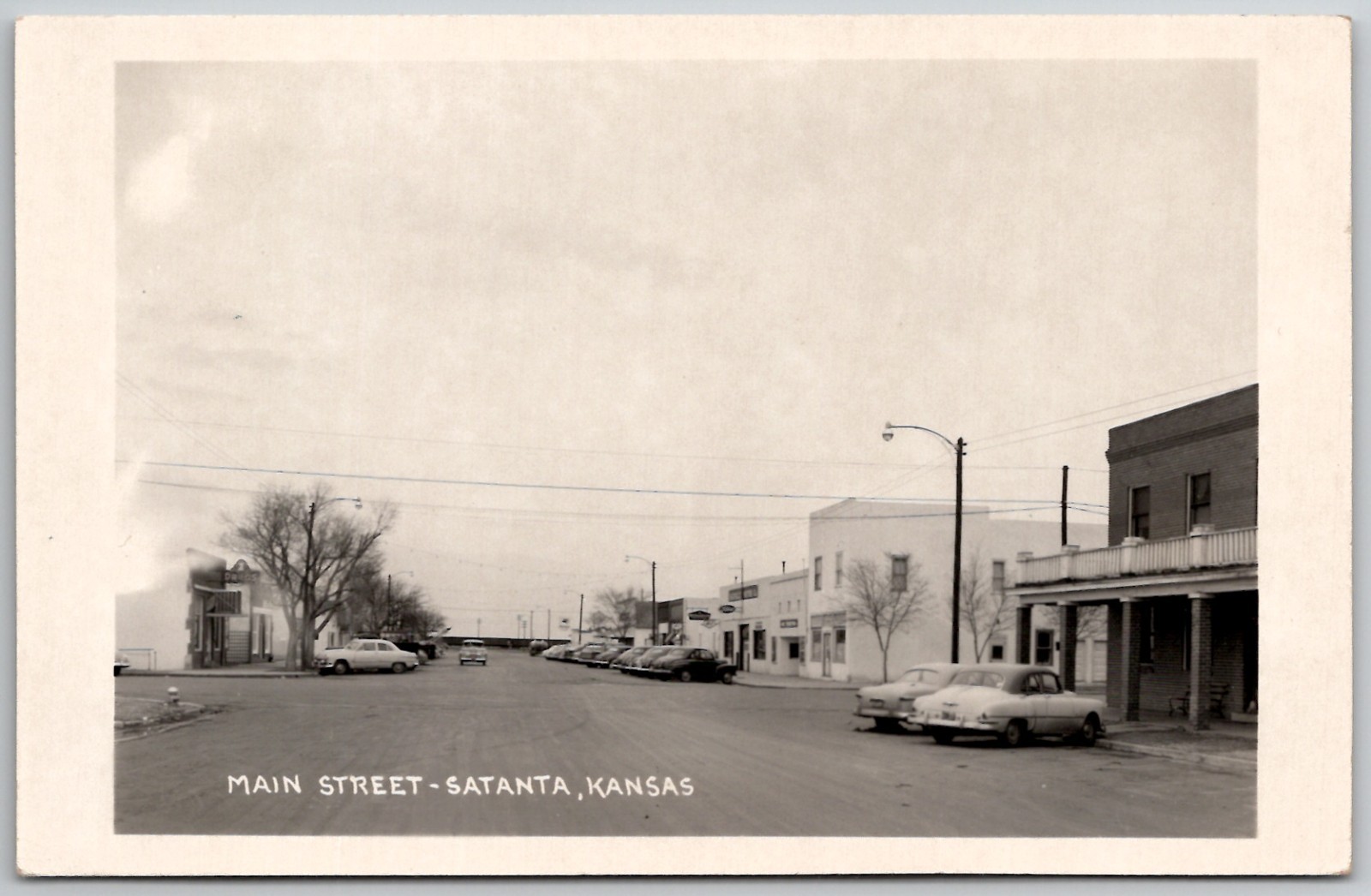 c1950s RPPC Main Street Satanta Kansas Old Cars Drug Store Unposted