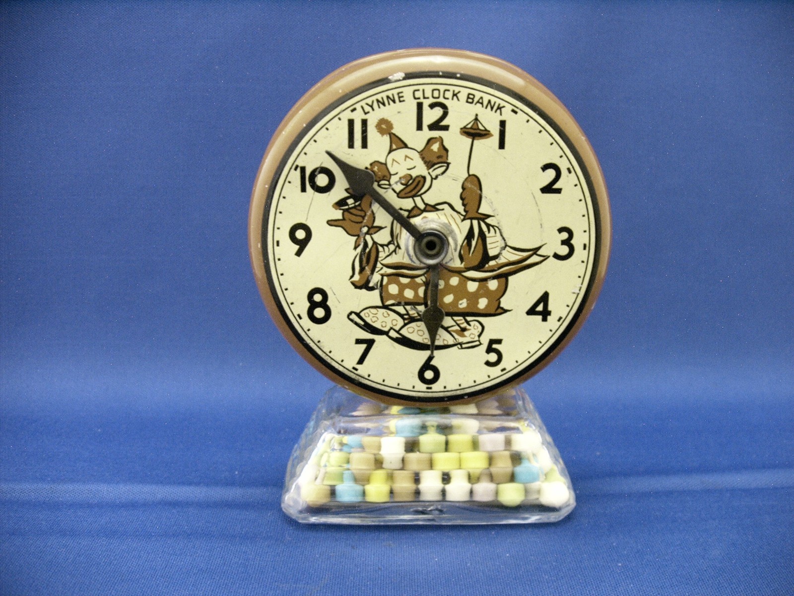 VINTAGE GLASS & TIN LYNNE CLOWN CLOCK BANK TOY CANDY CONTAINER CIRCA 1950 VINTAGE GLASS & TIN LYNNE CLOWN CLOCK BANK TOY CANDY CONTAINER CIRCA 1950