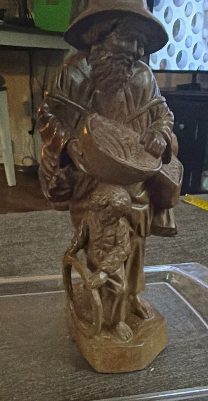 Vintage hand-carved wooden folk art figurine of a traveling man