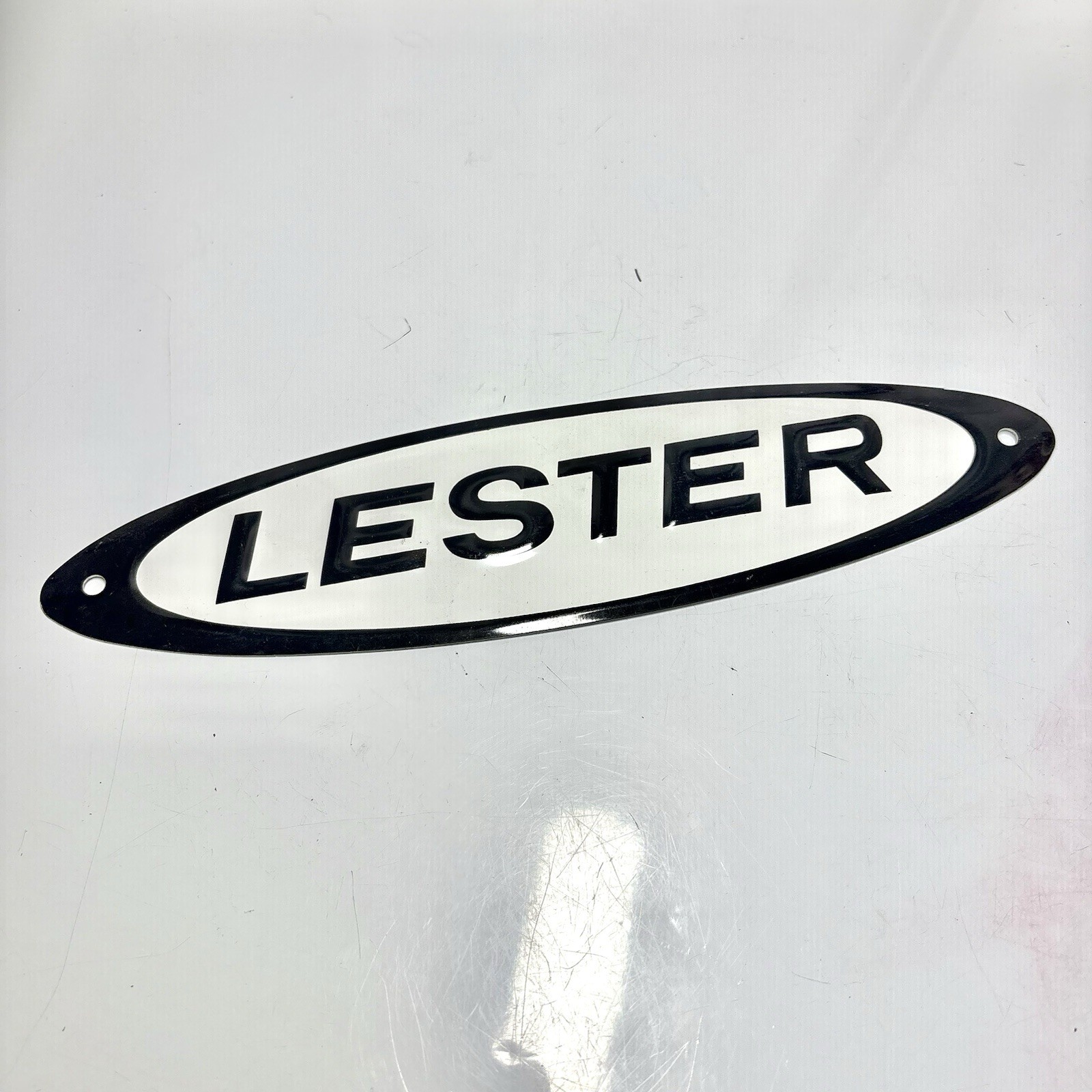 Vtg LESTER Buildings Embossed Tin Metal Sign Black White Advertising 10”