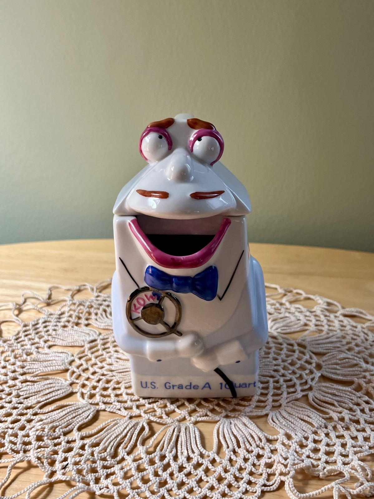 This is a vintage Disney Mr. Dairy ceramic milk creamer from Epcot.