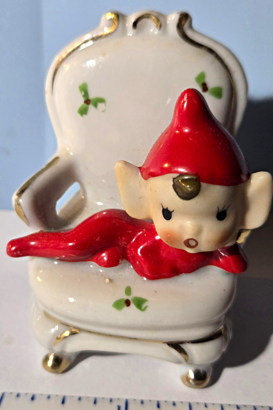 Vintage Ceramic Elf Figurine Reclining in White Chair, Red Hat and Suit 