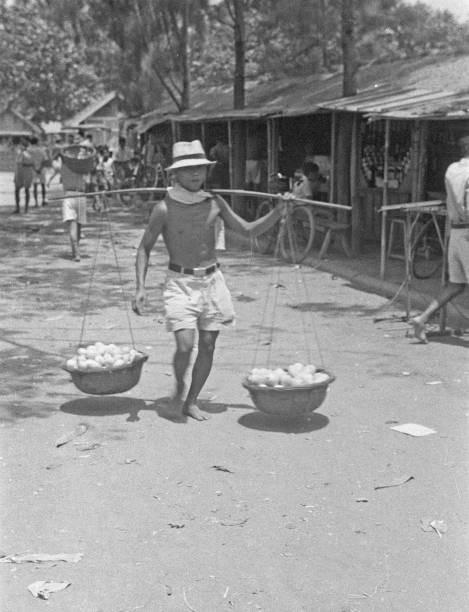 Fruit seller with baskets on yoke in Indonesia Dutch East Indies Old Photo