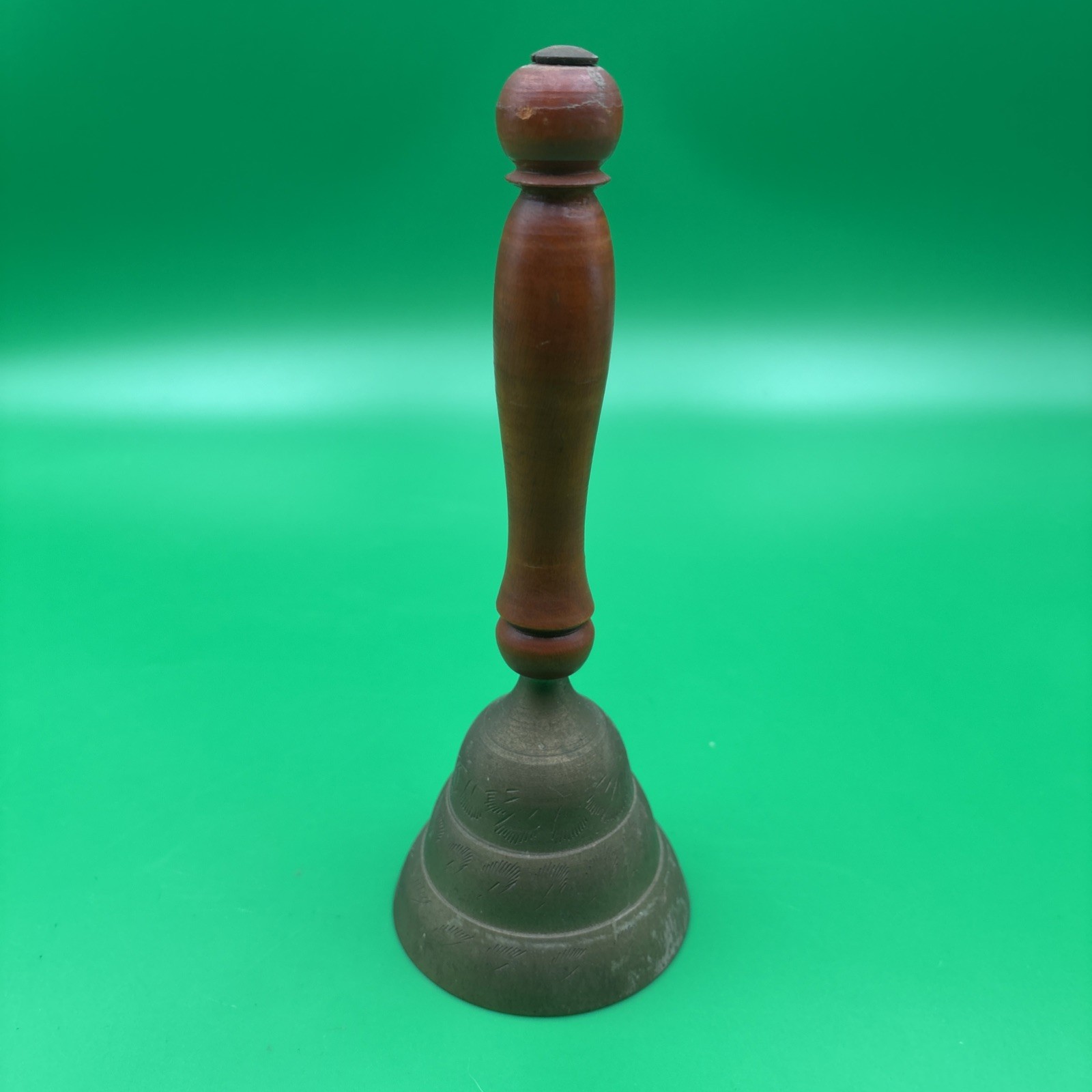 Vintage Etched Brass Hand Bell with Wood Handle. India Vintage Etched Brass Hand Bell with Wood Handle. India