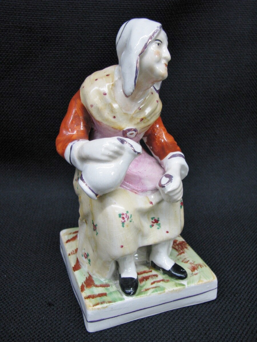 Antique Staffordshire Handpainted Seated Woman Pouring From A Pitcher; 1860's