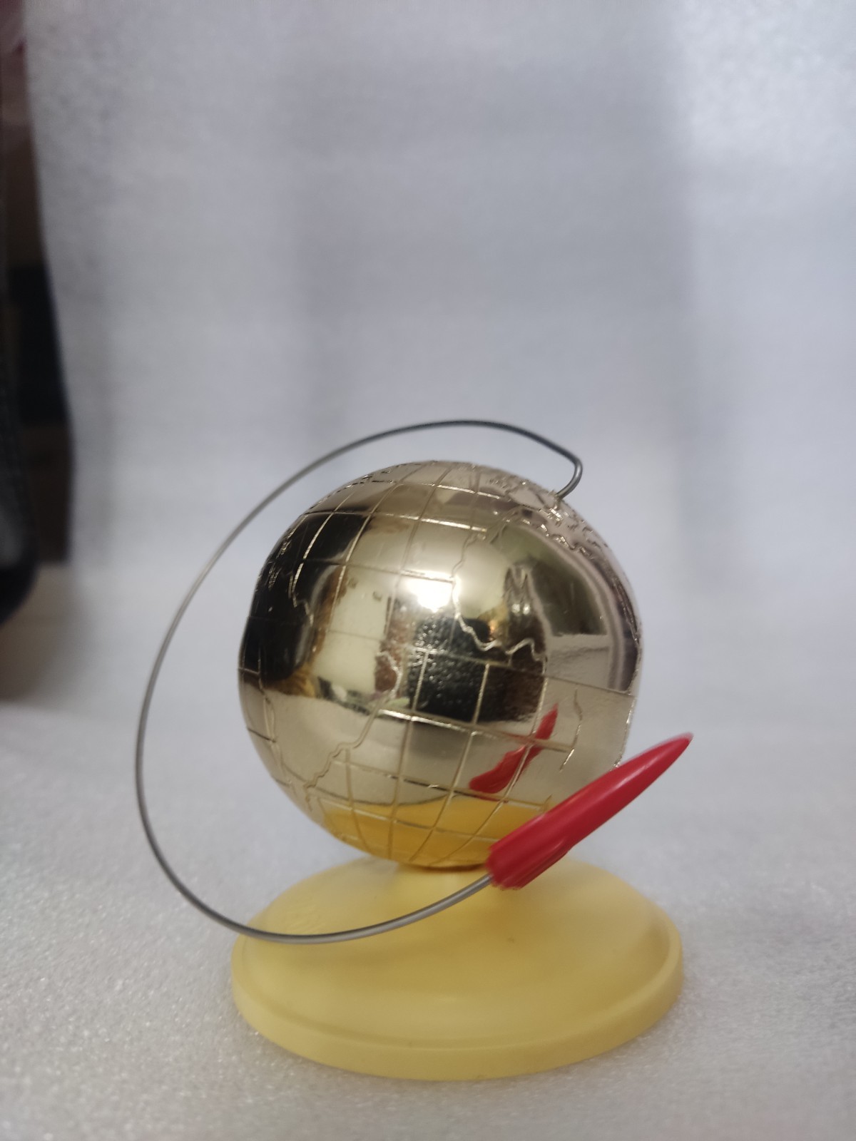 A globe with a space rocket. Soviet souvenir on the table, April 12, 1961,... A globe with a space rocket. Soviet souvenir on the table, April 12, 1961,...