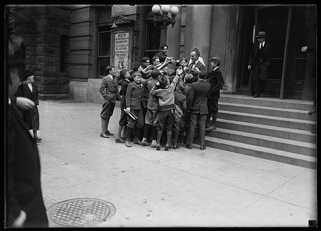 Photo:1924 New York City Boys Crowd Around Man on Steps Street Scene