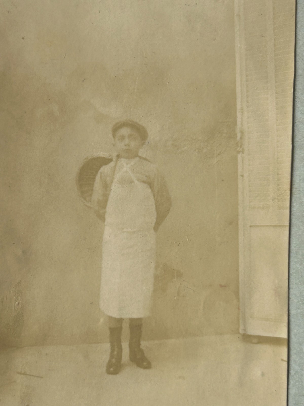 Antique Photograph of The Boy in White Arpon and Basket on The Back. Antique Photograph of The Boy in White Arpon and Basket on The Back.