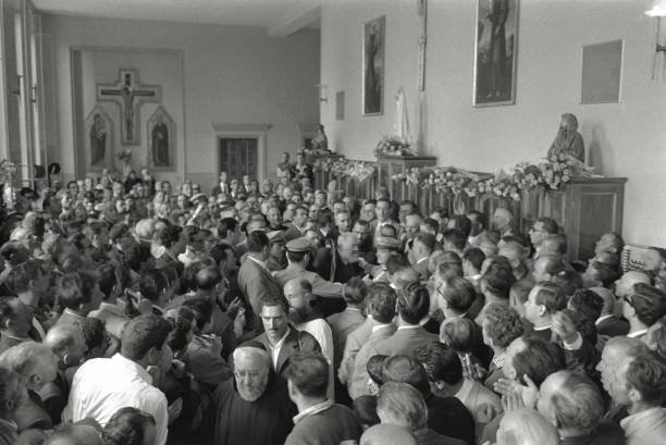 Crowd of believers surrounding Padre Pio of Pietralcina protected - Old Photo