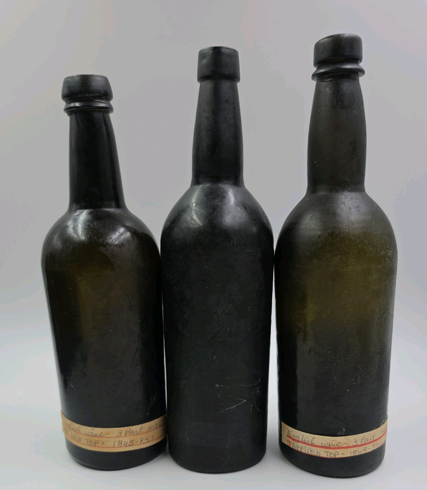 Set of 3- BLACK GREEN GLASS WINE BOTTLES 3 PIECE BLOWN MOLD 19th CENTURY ENGLAND Set of 3- BLACK GREEN GLASS WINE BOTTLES 3 PIECE BLOWN MOLD 19th CENTURY ENGLAND