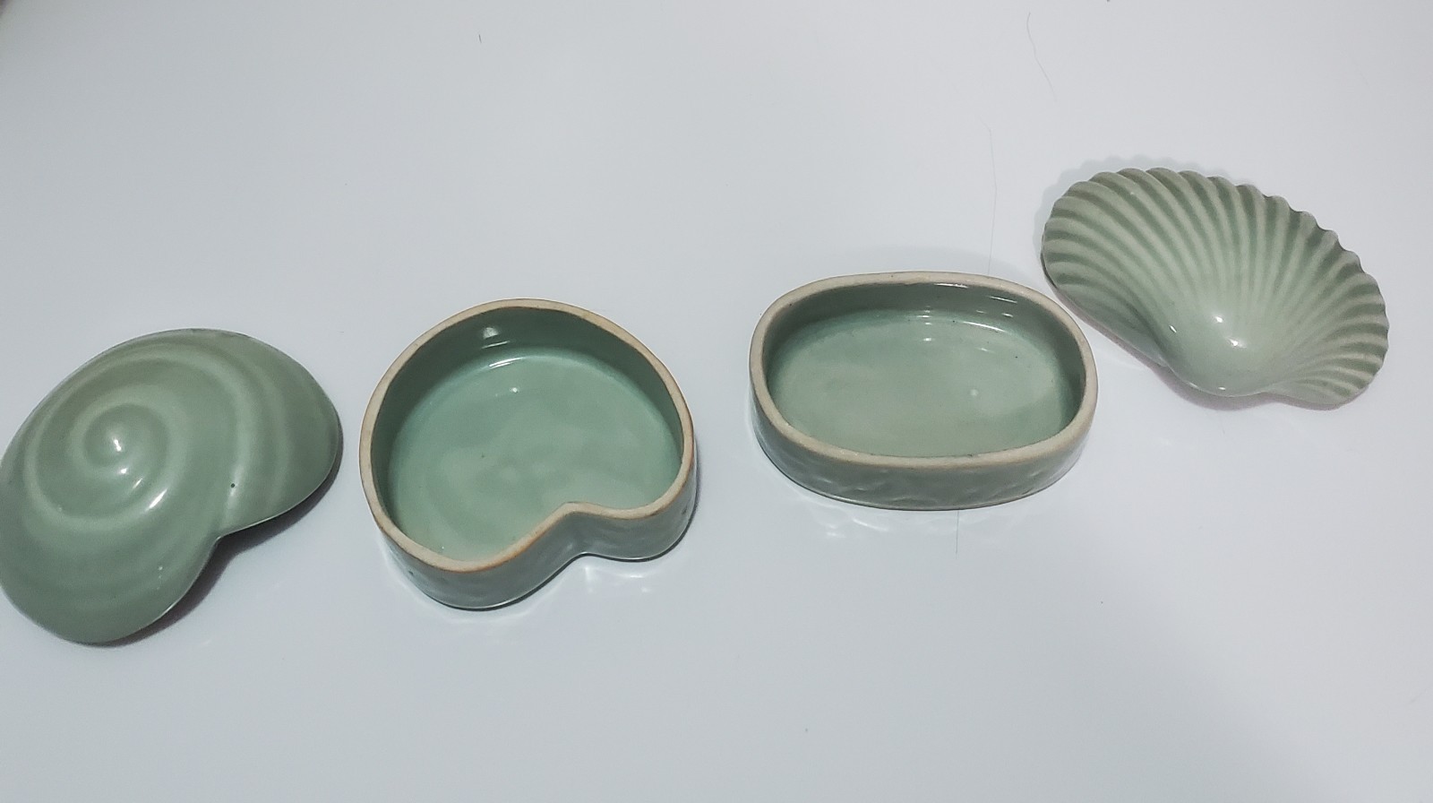 Celadon glazed ceramic spiral and sea shell trinket boxes Celadon glazed ceramic spiral and sea shell trinket boxes