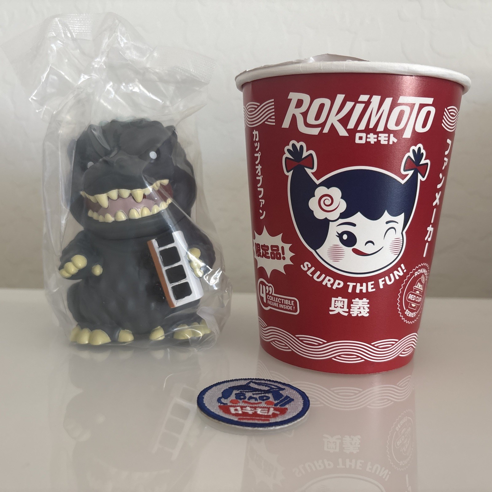 2026 Comic Con Rokimoto Super Godzilla w/Train Red Cup Figure w/Patch LE1000 2026 Comic Con Rokimoto Super Godzilla w/Train Red Cup Figure w/Patch LE1000