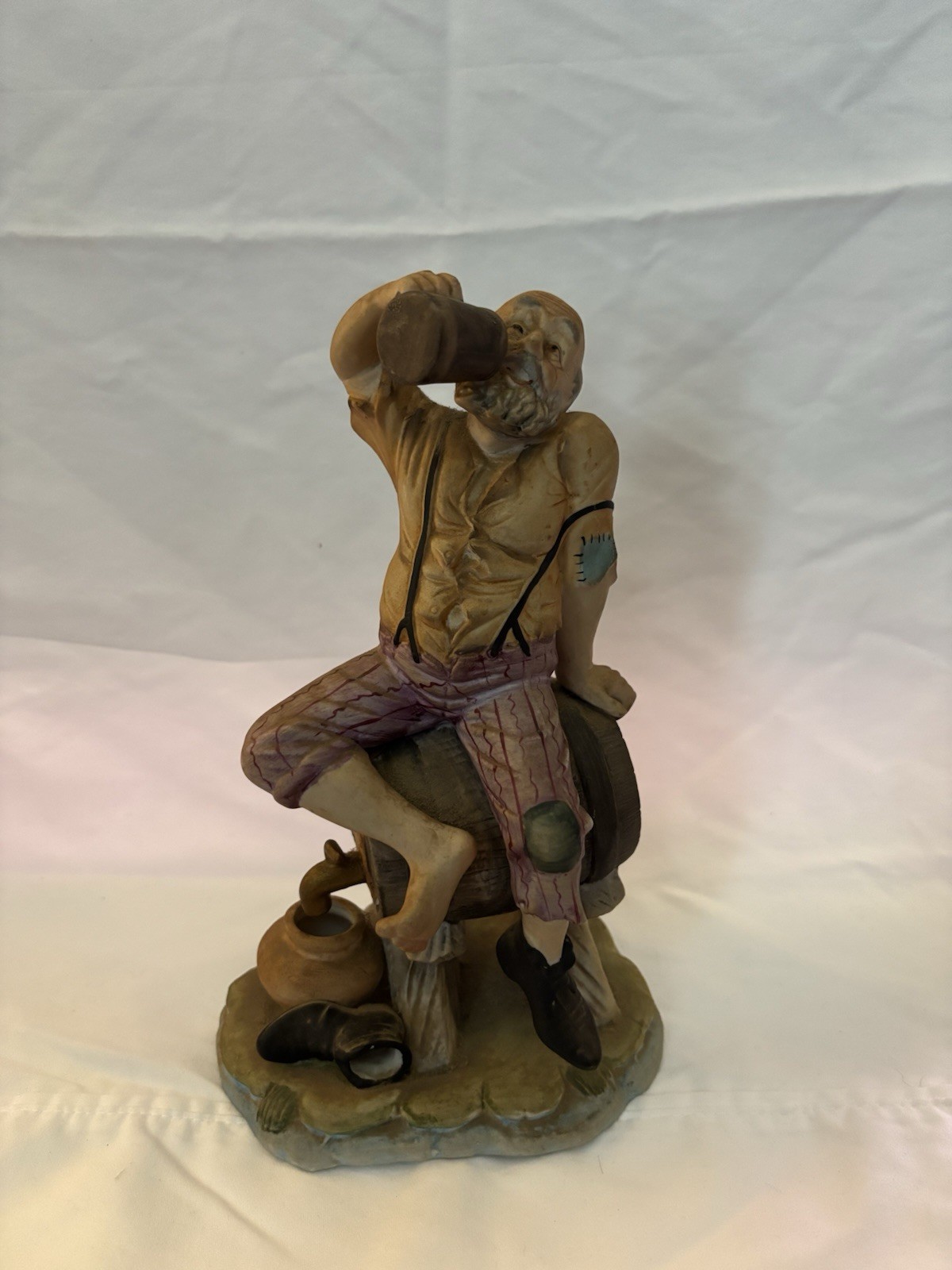 Statue Of Drunk Man On Barrel