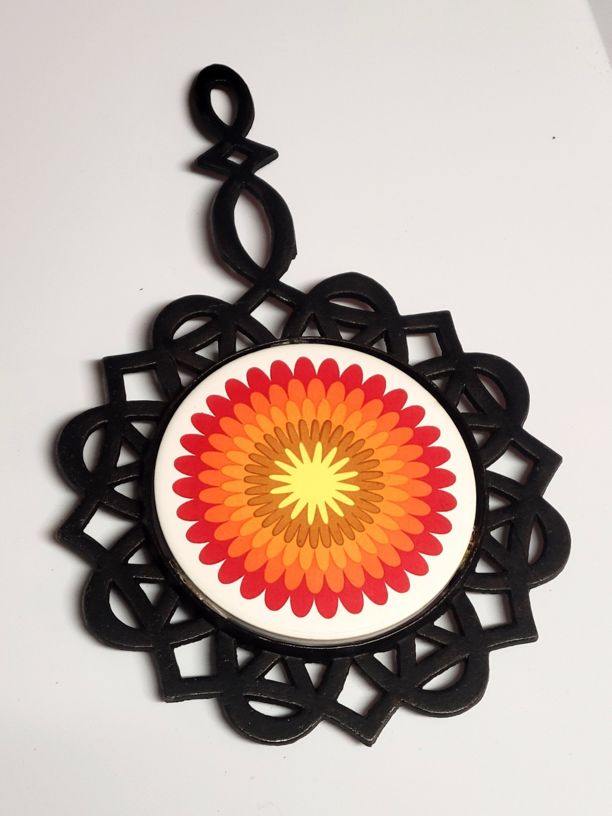 vintage 1970s psychedelic floral cast iron trivet and hot pad