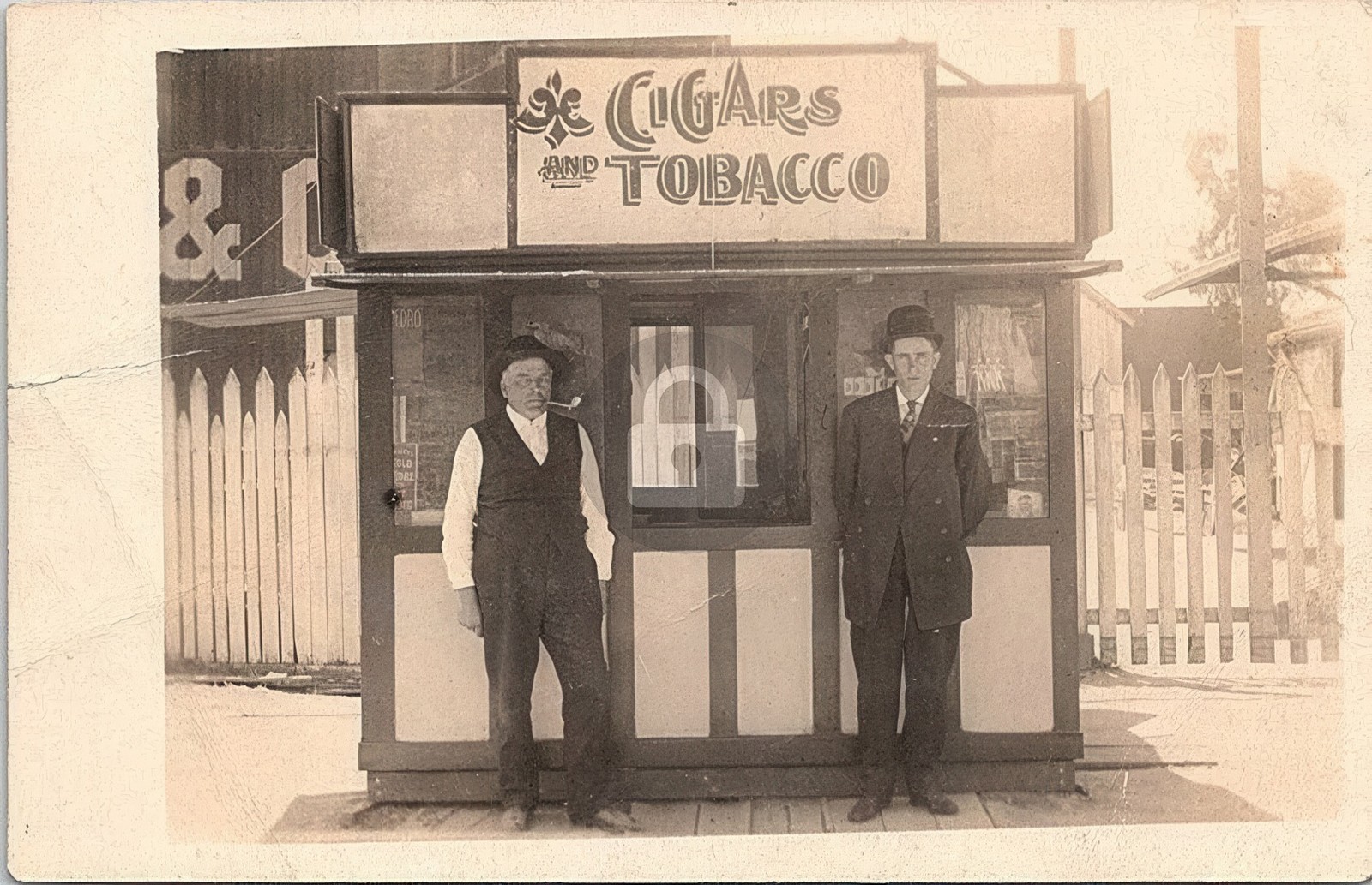 Two Men Posing in Front of Tobacco & Cigar Stand 1900s RPPC Photo Postcard COPY Two Men Posing in Front of Tobacco & Cigar Stand 1900s RPPC Photo Postcard COPY