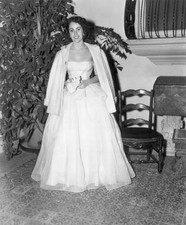 British-born actor Elizabeth Taylor wearing a gown holding a corsa- Old Photo picture