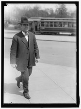 Photo:William E. Borah Walking in Suit and Hat with Streetcar Behind picture