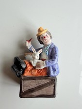 Vintage Clown Figurine Sitting on Crate Holding Rabbit picture