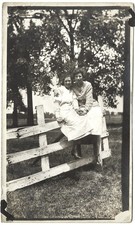 AFFECTIONATE Edwardian Women RPPC Photo Postcard Woman Sitting Fence Hold Hands picture