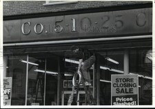 1992 Press Photo Worker removes letters from the J.J. Newberry storefront picture