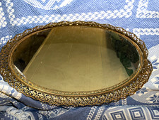 Vintage Oval Mirrored Vanity Tray with an Ornate Gold-Tone Metal Filigree Frame picture