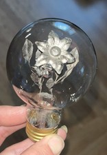 1930's AEROLUX light bulb featuring a unique design with a floral bouquet picture
