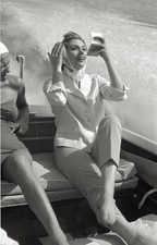 Sylva Koscina is seated on a boat looks at herself in a little mir- Old Photo picture