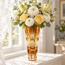 A vintage Bohemian amber cut-to-clear crystal vase with geometric star motifs. picture