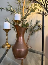 vintage, hand-hammered copper pitcher or jug with a bulbous body, a slender neck picture