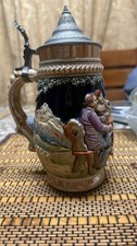VTGE German beer stein feat a hand-painted relief scene and a hinged pewter lid. picture