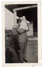 vintage 1900/10s snapshot photo man in top hat scared holding baby on shoulder picture