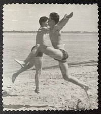 Beach Fun Sports Hover Jump Two handsome men trunks muscle bulge photo Gay Int picture