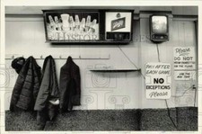 1985 Press Photo Signs and coats hanging inside Independence Cue Lounge, NC picture