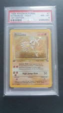 POKEMON CARD 1999 FOSSIL HITMONLEE HOLO 1ST EDITION #7 GRADED PSA 8 picture