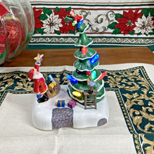 Holiday Time Light-up Musical Christmas Village Decorating The Tree 8.3