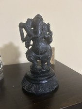 handcrafted black stone statue of Lord Ganesha in a dynamic dancing pose picture
