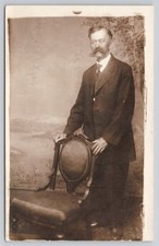 Older Gentleman Man Bushy Mustache Standing Behind Chair RPPC 1904-1918 Postcard picture