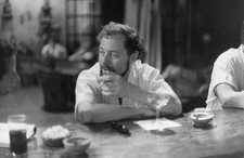 American playwright Tennessee Williams seated at a bar smoking a c- Old Photo picture